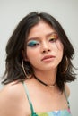 Fashion shot. Portrait of a beautiful young woman in trendy makeup with rainbow eye arrows. Make-up and cosmetics Royalty Free Stock Photo