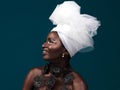 Fashion is a silent language. Studio shot of an attractive young woman posing in traditional African attire against a Royalty Free Stock Photo