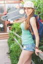 Fashion skateboarder young woman with a skateboard. Adventure, summer trip.