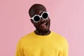 Fashion. Smiling black man in sunglasses colorful portrait
