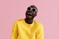 Fashion. Smiling black man in sunglasses colorful portrait