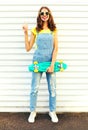 Fashion smiling young woman holds a skateboard having fun Royalty Free Stock Photo