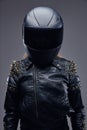 Fashion, sport, extreme. Portrait of a biker girl wearing leather racer costume and protective helmet in a studio on a Royalty Free Stock Photo