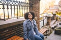 Fashion street style portrait of attractive young natural beauty African American woman with afro hair in blue coat Royalty Free Stock Photo