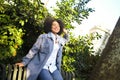 Fashion street style portrait of attractive young natural beauty African American woman with afro hair in blue coat Royalty Free Stock Photo