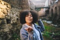 Fashion street style portrait of attractive young natural beauty African American woman with afro hair in blue coat Royalty Free Stock Photo