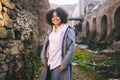 Fashion street style portrait of attractive young natural beauty African American woman with afro hair in blue coat Royalty Free Stock Photo