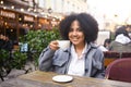 Fashion street style portrait of attractive young natural beauty African American woman with afro hair in tweed jacket Royalty Free Stock Photo