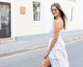 Fashion and streetstyle. Portrait of a girl in a light white dress and sunglasses and beautiful vintage earrings posing Royalty Free Stock Photo