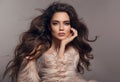 Fashion studio photo of gorgeous brunette woman with long h