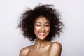 Fashion studio portrait of beautiful african american woman with perfect smooth glowing mulatto skin, make up