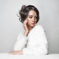 Beautiful woman with elegant hairstyle in white fur coat Royalty Free Stock Photo