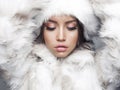 Beautiful woman in white fur coat and fur hat Royalty Free Stock Photo