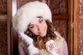 Fashion studio portrait of beautiful lady in white fur coat and fur hat mittens.Winter beauty in luxury. Fashion fur Royalty Free Stock Photo