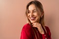 Fashion studio portrait of a happy young blonde woman posing over pink background. Royalty Free Stock Photo