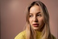 Fashion studio portrait of young blonde woman posing over pink background. Royalty Free Stock Photo