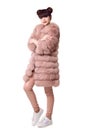 Fashion studio teen look style in pink fur coat and trendy shoes Royalty Free Stock Photo