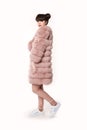 Fashion studio teen look style in pink fur coat and trendy shoes Royalty Free Stock Photo