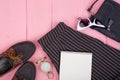 fashion stuff - bag, trousers, sunglasses, compass, shoes, blank note pad on pink wooden background Royalty Free Stock Photo