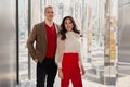 Fashion style Clothes, business casual. Respectable Businessman Wearing brown jacket and sweater and Woman in red pants