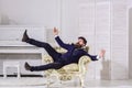 Fashion and style concept. Man with beard and mustache wearing fashionable classic suit, sits, jumps on old fashioned