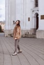 Fashion style portrait. beautiful stylish girl with long hair walks in the city. Portrait of attractive girl on the street. Spring Royalty Free Stock Photo