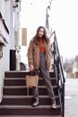 Fashion style portrait. beautiful stylish girl with long hair walks in the city. Portrait of attractive girl on the Royalty Free Stock Photo