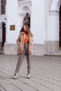 Fashion style portrait. beautiful stylish girl with long hair walks in the city. Portrait of attractive girl on the Royalty Free Stock Photo