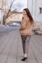 Fashion style portrait. beautiful stylish girl with long hair walks in the city. Portrait of attractive girl on the Royalty Free Stock Photo