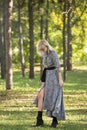 Fashion style portrait of gorgeous beautiful woman posing in summer green park