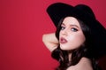 Fashion style portrait of trendy girl in black hat. Elegant lady. Sensual woman vogue. Royalty Free Stock Photo