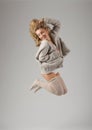 Fashion style portrait of young jumping girl