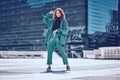 Fashion, style and woman on rooftop in city with stylish, trendy and modern outfit. Summer, freedom and carefree girl in Royalty Free Stock Photo