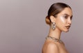 Beauty fashion portrait of young woman with big lips, looking in profile. Stylish female model with silver jewelery. Royalty Free Stock Photo