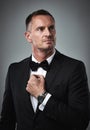Fashion, success and mature man in tuxedo, handsome online dating profile picture isolated on grey background in studio