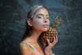 Fashion summer makeup. Abstract summer makeup. Pineapple fruit. Fashion girl with colorful powder make up. Colourful