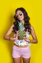Fashion summer funny portrait indian girl with pineapple over yellow background Royalty Free Stock Photo