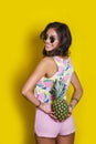 Fashion summer portrait smiling indian girl in sunglasses and pineapple over yellow background Royalty Free Stock Photo