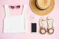 Fashion summer women`s clothes set with accessories on pink background with empty screen smart phone, Flat lay, Top view Royalty Free Stock Photo