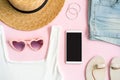 Fashion summer women`s clothes set with accessories on pink background with empty screen smart phone, Flat lay, Top view Royalty Free Stock Photo