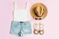 Fashion summer women`s clothes set with accessories on pink background, Flat lay, Top view Royalty Free Stock Photo