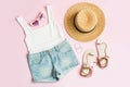 Fashion summer women`s clothes set with accessories on pink background, Flat lay, Top view Royalty Free Stock Photo