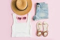 Fashion summer women`s clothes set with accessories on pink background Royalty Free Stock Photo