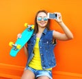 Fashion and technology concept - stylish young girl in colorful Royalty Free Stock Photo