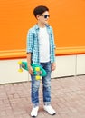 Fashion teenager boy wearing a shirt, sunglasses and skateboard Royalty Free Stock Photo