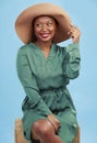 Fashion, thinking and happy black woman with travel style for summer isolated in a studio blue background. African, hat Royalty Free Stock Photo