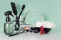 Fashion toiletry accessories, cosmetics in black in green mint menthe bathroom interior - mirror, spray, sponge, red nail polish.