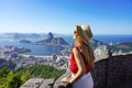 Fashion tourist woman on terrace in Rio de Janeiro with the famous Guanabara bay and the cityscape of Rio de Janerio, Brazil