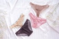 Fashion trendy lace lingerie. Different panties on white bed background. Beautiful sets to choose from. Colorful women's underwea