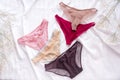 Fashion trendy lace lingerie. Different panties on white bed background. Beautiful sets to choose from. Colorful women's underwea